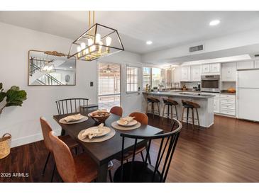 Stylish dining room features a modern light fixture and a mirror at 1525 E Southern Ave, Tempe, AZ 85282