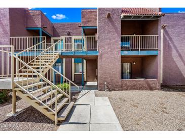 Apartment complex with exterior stairs and gravel landscaping at 16602 N 25Th St # 114, Phoenix, AZ 85032