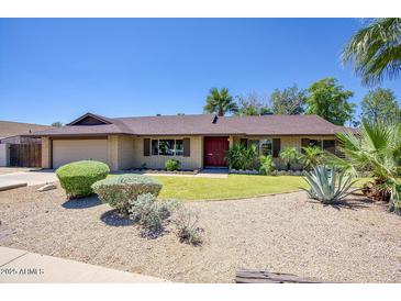 Charming single-story brick home with well-maintained landscaping and desert accents at 3009 W Christy Dr, Phoenix, AZ 85029