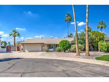 Charming single-story home with a well-maintained front yard, mature trees, and a two-car garage in a desirable neighborhood at 5119 N 87Th St, Scottsdale, AZ 85250