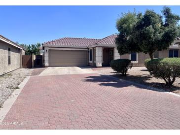 Attractive single-story home with a red brick driveway and mature landscaping at 6049 S Wilson Dr, Chandler, AZ 85249
