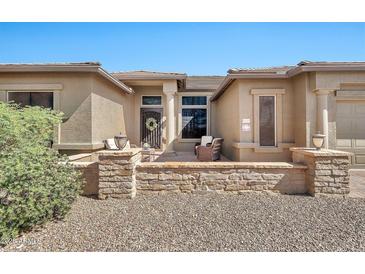 Inviting front entrance with stone accents, lovely front door, and cozy seating area at 6131 S Bradshaw Way, Chandler, AZ 85249