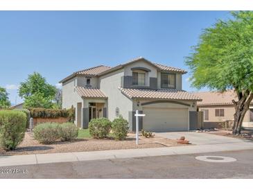 Charming two-story home with a neutral color palette and a well-maintained front yard at 6321 W Gross Ave, Phoenix, AZ 85043