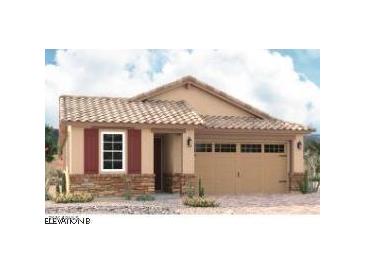 Charming one-story home featuring a two-car garage, stone accents, and a tile roof at 8713 S 170Th Ave, Goodyear, AZ 85338