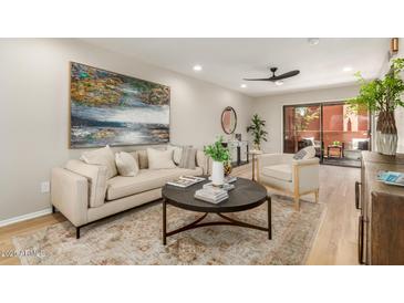 Inviting living room features modern decor, neutral tones, and access to an outdoor patio at 12222 N Paradise Village S Pkwy # 237, Phoenix, AZ 85032