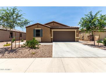 Charming single-story home featuring a desert-landscaped front yard and a two-car garage at 128 S 200Th Ave, Buckeye, AZ 85326