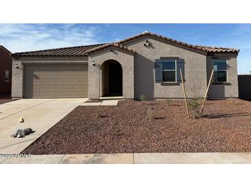 Single-level home featuring a low-maintenance front yard, a two-car garage, and an arched entryway at 1418 E Jacqueline Pl, Casa Grande, AZ 85122