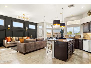A stylish open-concept living space with a modern kitchen and cozy seating area at 14826 N 92Nd Pl, Scottsdale, AZ 85260