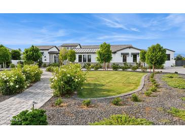 Stunning front yard of home featuring manicured lawn, stone walkway and lush landscaping at 4024 E Minton Cir, Mesa, AZ 85215