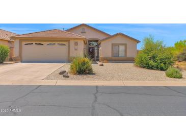 Charming single-story home with desert landscaping, two car garage, and a gated front entry at 4611 E Night Glow Dr, Cave Creek, AZ 85331