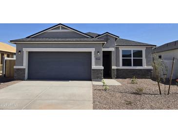 Charming single-Gathering home featuring a two-car garage and stone accents on the facade at 5491 E Mearn Rd, San Tan Valley, AZ 85140