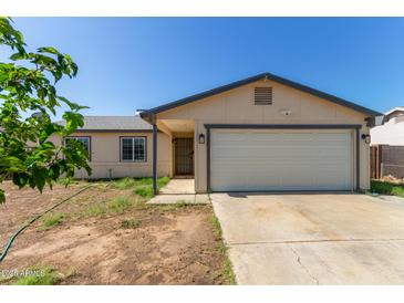 Charming single-story home featuring a neutral color palette, attached garage, and a low-maintenance front yard at 8051 W Mariposa Dr, Phoenix, AZ 85033
