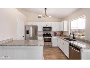 Modern kitchen features stainless steel appliances and granite countertops at 8103 E Dartmouth St, Mesa, AZ 85207