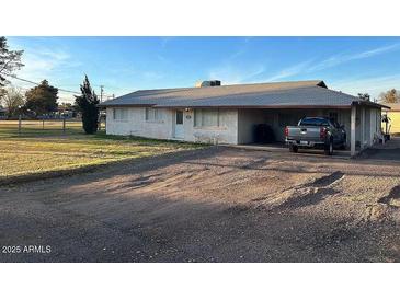 Charming single-story home with a spacious front yard and covered parking area at 834 E Lockwood St, Mesa, AZ 85203