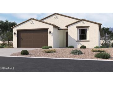 Charming single-story home with a two-car garage and desert landscaping at 9531 W Parkway Dr, Tolleson, AZ 85353