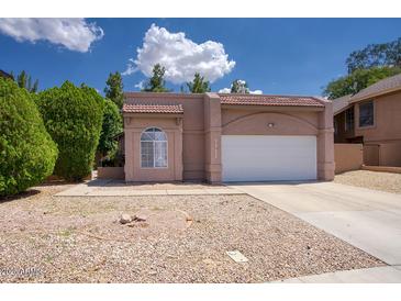 Charming single-story home with a two-car garage, rock landscaping, and well-maintained front yard at 1117 W Manor St, Chandler, AZ 85224