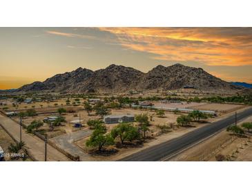Expansive ranch property with horse facilities nestled against a scenic mountain backdrop at 11912 N Thunderbird Rd, Maricopa, AZ 85139
