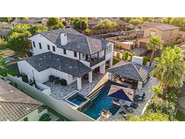 Stunning aerial view of a two-story home with a pool, spa, and covered outdoor living area at 20866 W Werner Pl, Buckeye, AZ 85396