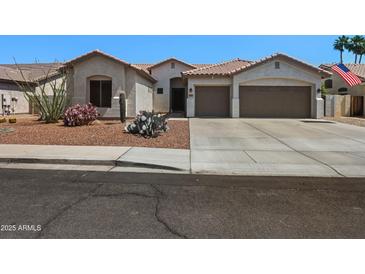 Charming single-story home boasts a three-car garage, well-kept desert landscaping, and a cozy front entryway at 2270 E Indian Wells Dr, Chandler, AZ 85249