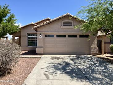 Charming single-story home with a two-car garage and well-maintained landscaping at 22963 W La Pasada Blvd, Buckeye, AZ 85326