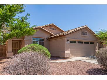 Charming single-story home with well-maintained landscaping and a two-car garage at 22963 W La Pasada Blvd, Buckeye, AZ 85326