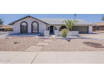 Charming single-story home with desert landscaping and a welcoming arched entryway at 2307 W Nido Ave, Mesa, AZ 85202