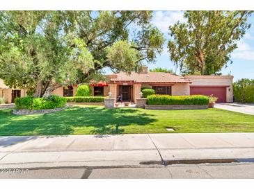 Charming single-story home with a well-manicured front yard and mature trees at 3027 N Nebraska St, Chandler, AZ 85225