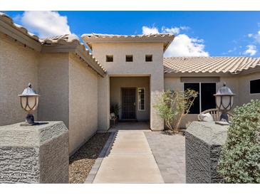 Inviting front entrance showcasing desert landscaping and stylish exterior lighting on concrete pillar feature at 3658 E Pony Track Ln, San Tan Valley, AZ 85140