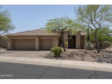 Charming single-story home featuring a three-car garage and desert landscaping, located in a desirable neighborhood at 6917 E Night Glow Cir, Scottsdale, AZ 85266