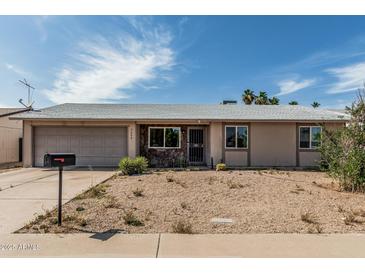 Charming single-story home with desert landscaping, attached garage and stone accents at 3208 W Wagoner Rd, Phoenix, AZ 85053