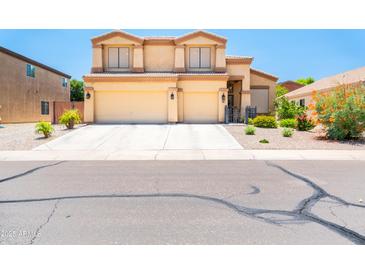 Charming two-story home boasts a spacious three-car garage and well-maintained landscaping at 3511 W Allens Peak Dr, San Tan Valley, AZ 85144