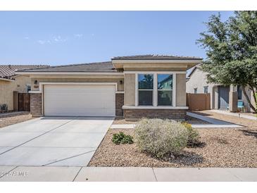 Charming single-story home featuring a two-car garage and low maintenance desert landscaping at 41279 W Elm Dr, Maricopa, AZ 85138
