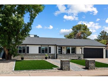 Charming single-story home featuring a landscaped front yard and stone accents at 4136 E Eugie Ave, Phoenix, AZ 85032