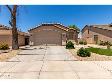 Inviting single-story home with a well-maintained lawn and a spacious two-car garage at 42458 W Desert Fairways Dr, Maricopa, AZ 85138