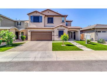 Charming two-story home featuring a well-maintained lawn and attached two-car garage at 550 E Zion Pl, Chandler, AZ 85249