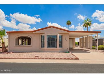 Charming home featuring low maintenance landscaping and covered parking on a sunny day at 8103 E Southern #303 Ave, Mesa, AZ 85209
