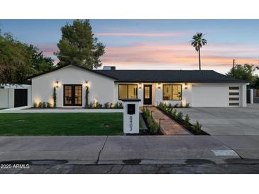 Charming home boasts fresh landscaping, updated lighting fixtures, and a well-manicured front yard at 8403 E Fairmount Ave, Scottsdale, AZ 85251