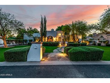 Beautiful home featuring manicured landscaping, a stone walkway, and stunning architecture at dusk at 9310 S Bala Dr, Tempe, AZ 85284