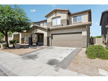 Charming two-story home featuring a two-car garage and well-maintained landscaping at 9420 S 35Th Gln, Laveen, AZ 85339