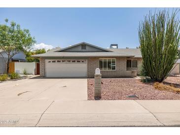 Charming single-story brick home with a two-car garage, and xeriscaping at 2119 E Sesame St, Tempe, AZ 85283