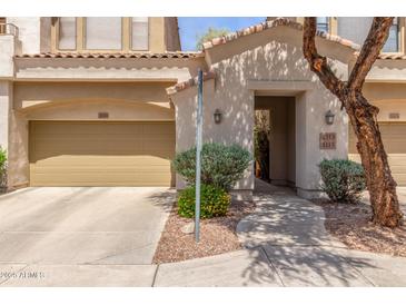 Inviting home exterior features a two-car garage and a charming walkway to the front door at 3131 E Legacy Dr # 2113, Phoenix, AZ 85042