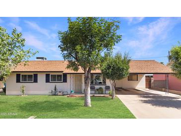 Charming home with lush front yard, mature trees and covered parking at 4122 W Las Palmaritas Dr, Phoenix, AZ 85051