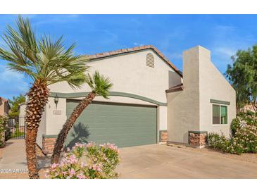 Charming single-Gathering home featuring desert landscaping, a two-car garage and a welcoming front entrance at 7031 S 32Nd Pl, Phoenix, AZ 85042
