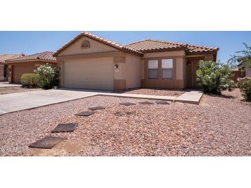 Charming single-story home with a well-maintained yard, desert landscaping, and a two-car garage at 8055 W Sanna St, Peoria, AZ 85345