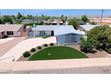 Charming single-story home featuring a well-manicured front yard with mature landscaping at 8750 E Starlight Way, Scottsdale, AZ 85250