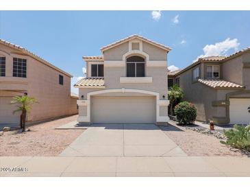 Charming two-story home featuring a neutral color palette, well-maintained landscaping and a two car garage at 1453 E South Fork Dr, Phoenix, AZ 85048