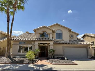 Charming two-story home featuring a tile roof, well-maintained landscaping, and a welcoming front entrance at 16242 S 12Th Pl, Phoenix, AZ 85048
