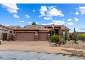 Charming single-story home featuring a three-car garage, desert landscaping, and a welcoming entrance at 2761 W Via Calabria --, Phoenix, AZ 85086
