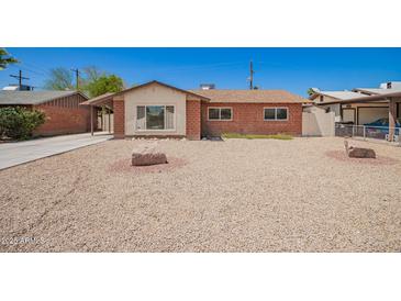 Charming single-story brick home with desert landscaping, creating an inviting curb appeal at 3644 W Maryland Ave, Phoenix, AZ 85019
