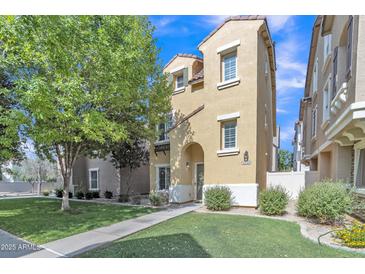 Charming two-story home features a well-maintained lawn and inviting curb appeal on a sunny day at 4159 E Jasper Dr, Gilbert, AZ 85296
